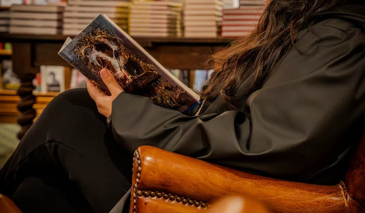 A person reading a book in a library