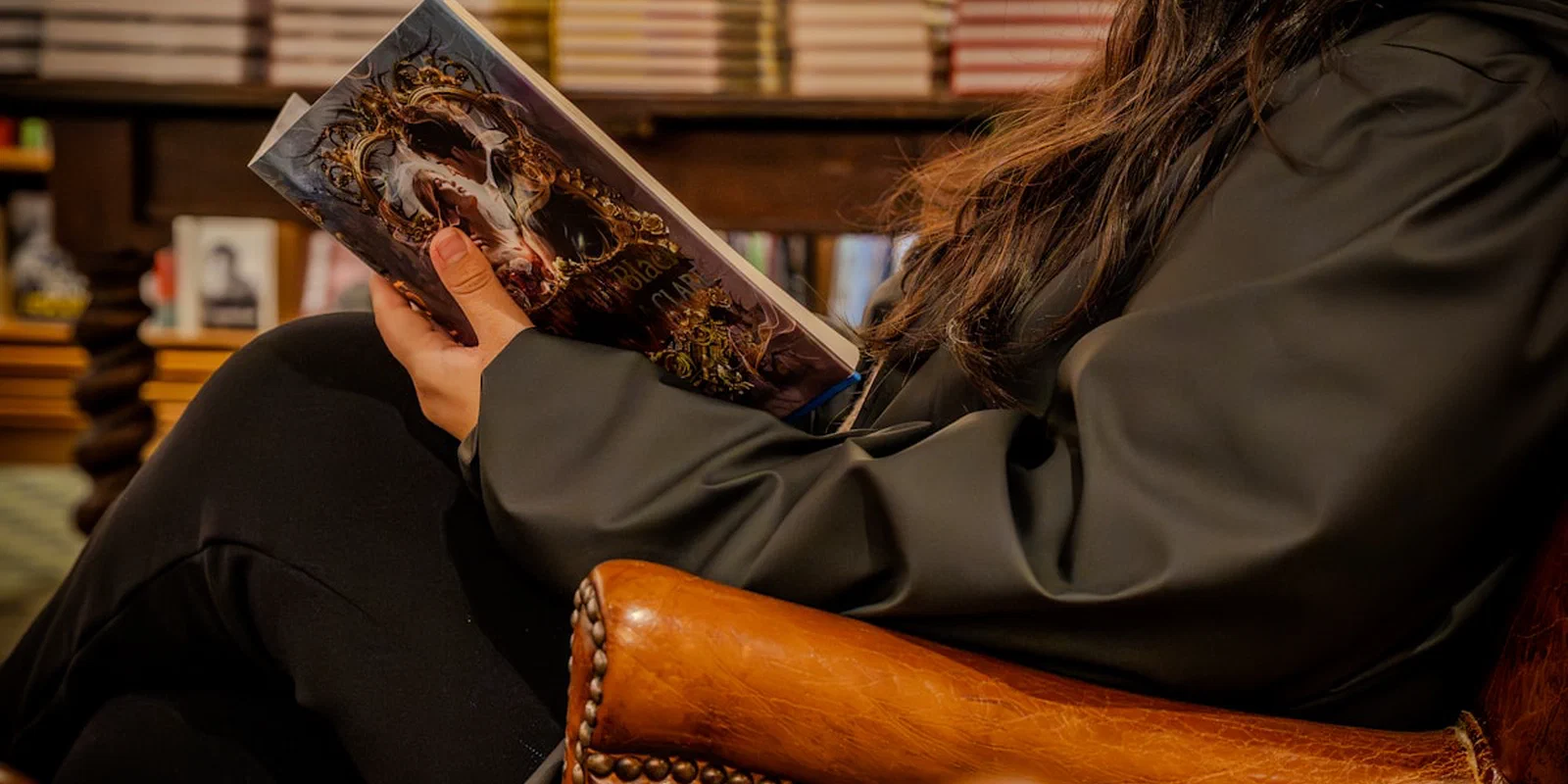 A person reading a book in a library