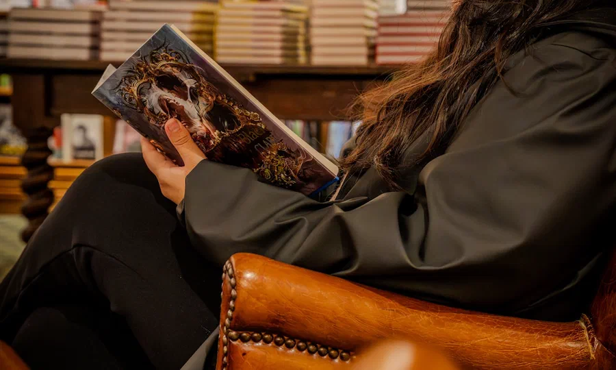 A person reading a book in a library