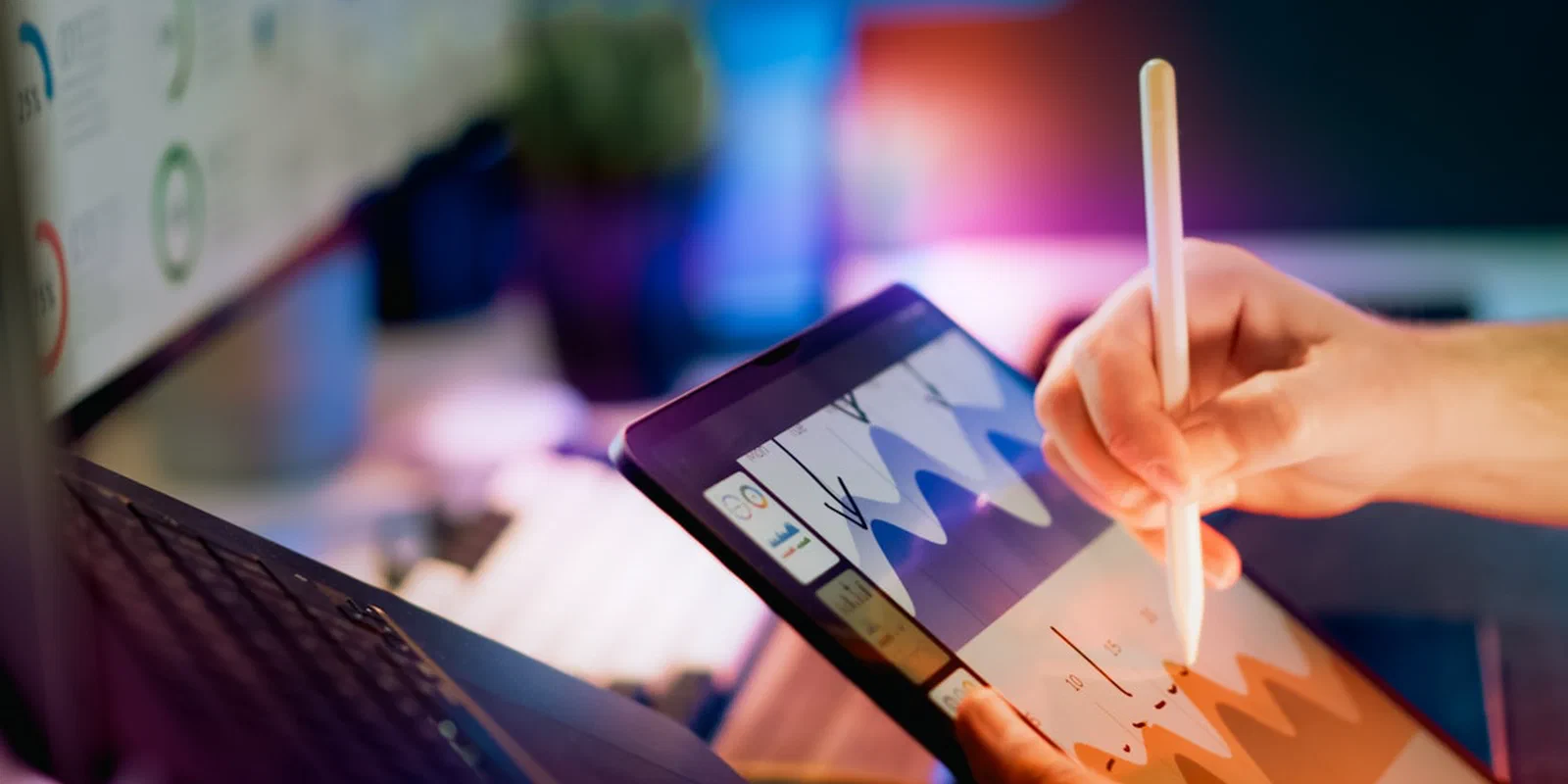 A person analyzing charts on a tablet