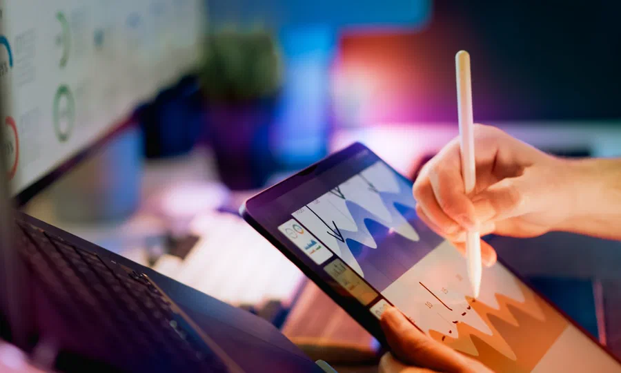A person analyzing charts on a tablet