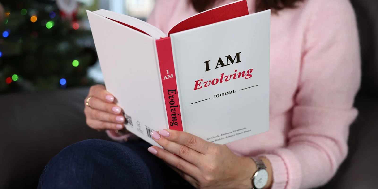 A person reading a journal about personal growth