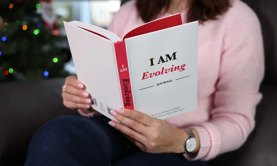 A person reading a journal about personal growth