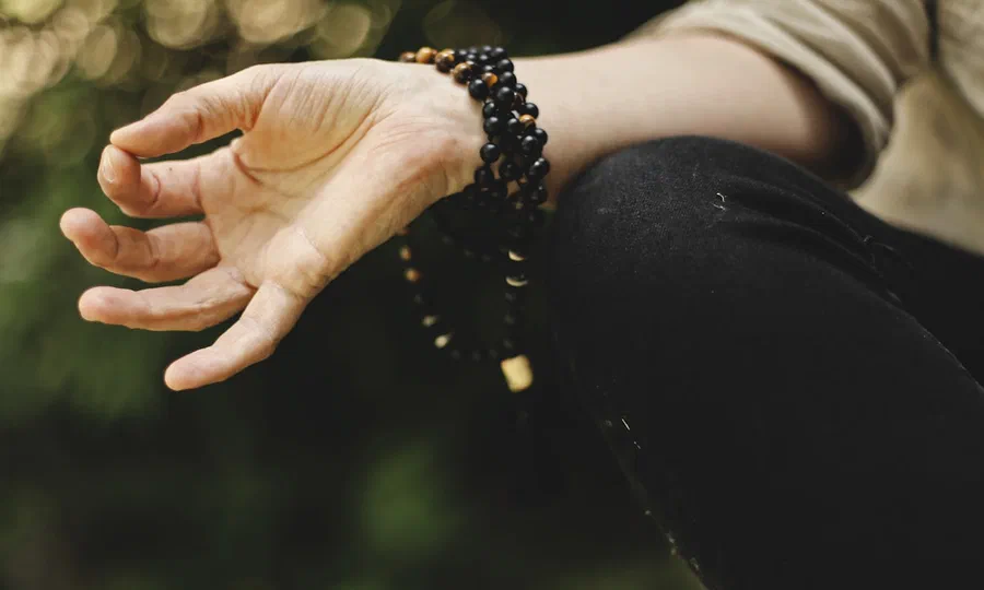 A person meditating outdoors
